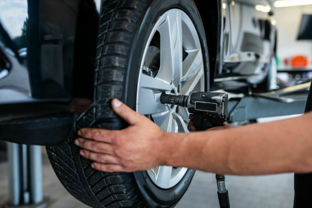 A mechanic changes a tire