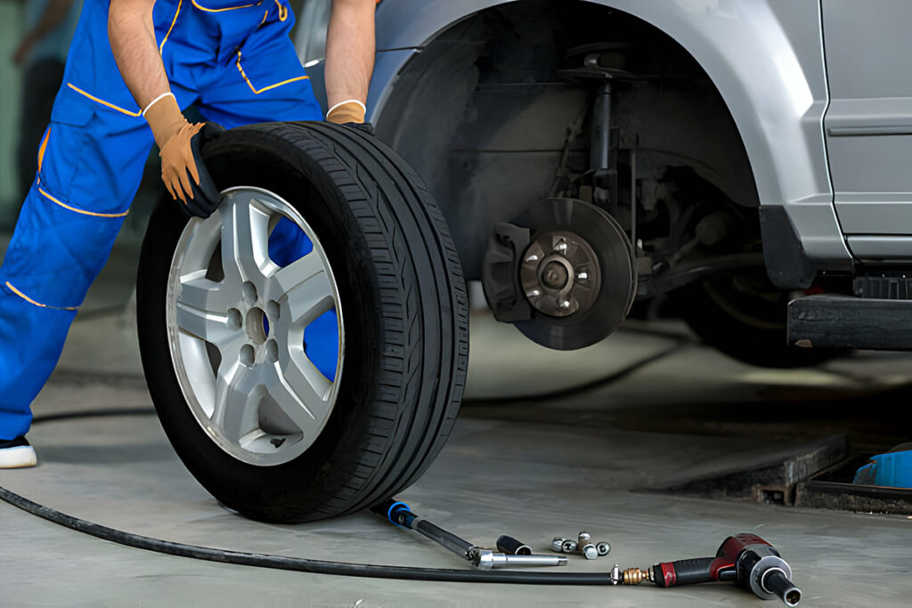 mechanic changing a wheel of a modern car in a workshop