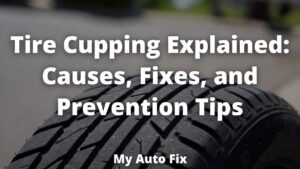 Close-up of a black car tire showing clear signs of tire cupping with scalloped, dipped patches and uneven tread wear on a paved road surface